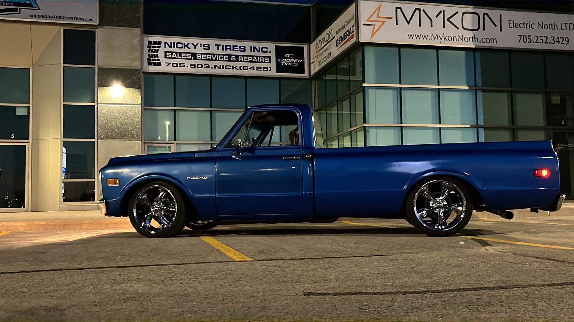 Classic blue pickup truck with aftermarket wheels at Nicky's Tires