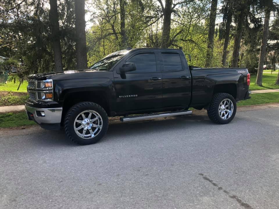 Black Silverado with aftermarket wheels and tires