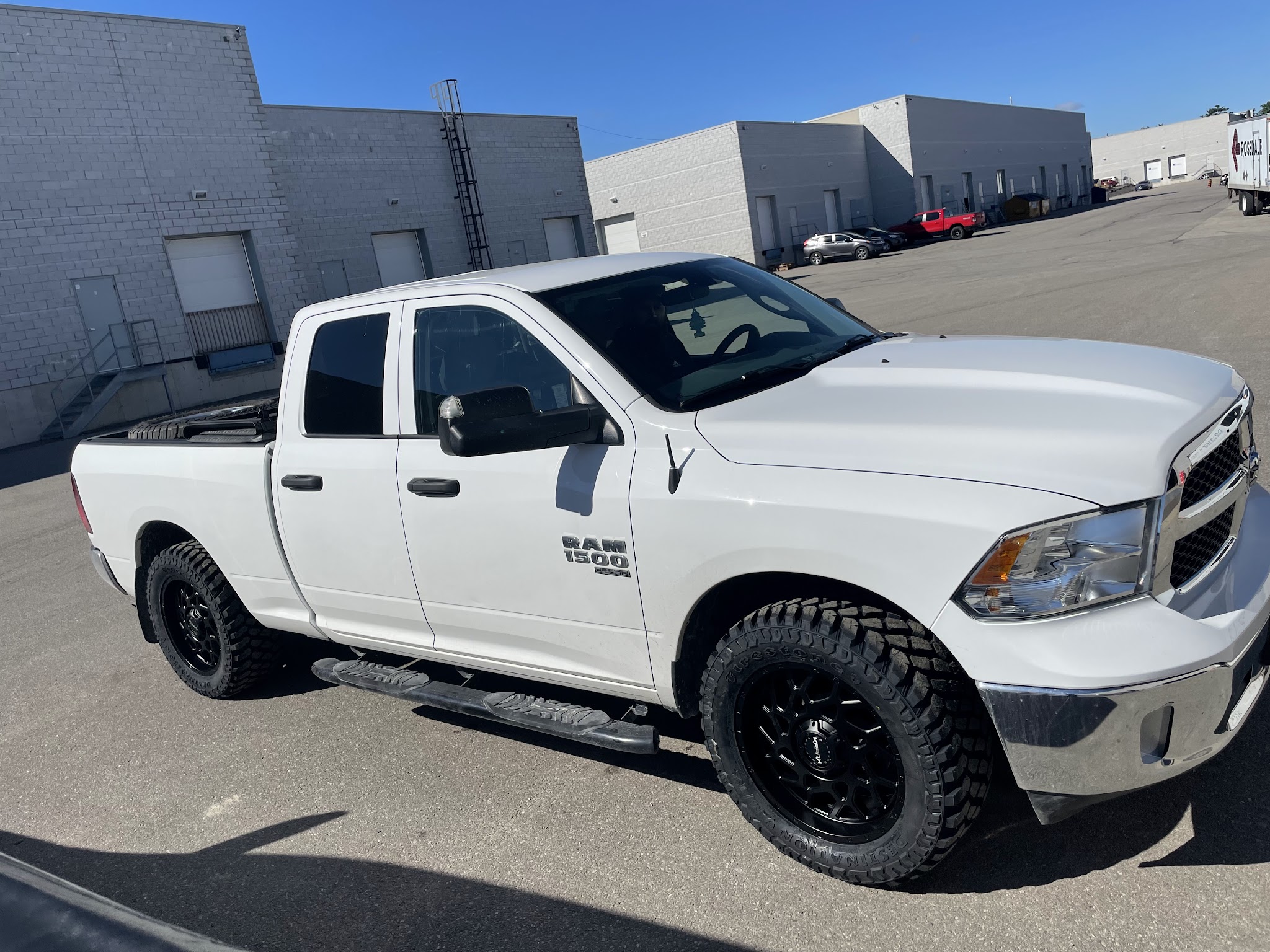 White Ram truck with new black off-road wheels and tires